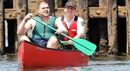 Rangers at Fort Totten teach canoeing on bay