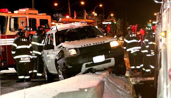 Vehicle wedged on roadway divider
