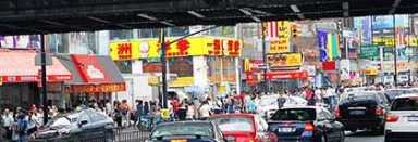 Flushing board wants bilingual store signs now