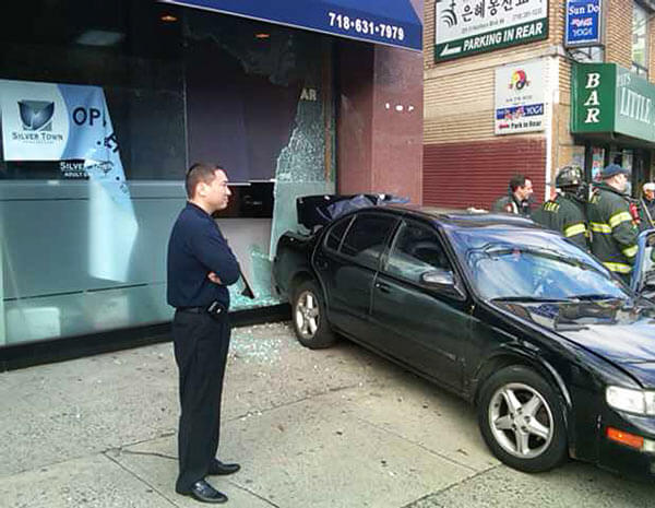Car breaks glass doors at center in Little Neck