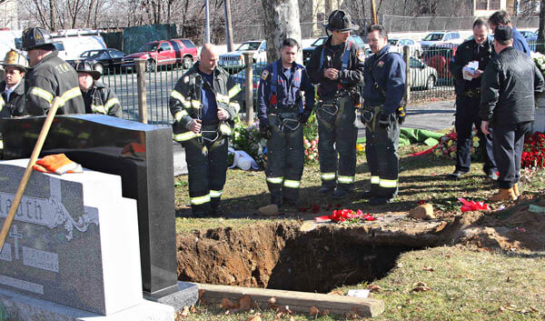 Cemetery workers injured after fall into open grave
