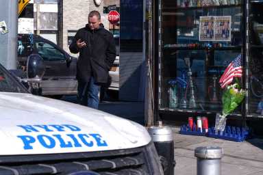 A shrine in front of a bodega steps from the 102nd Precinct memorializes Det. Brian Simonsen, a regular who was struck down by friendly fire.