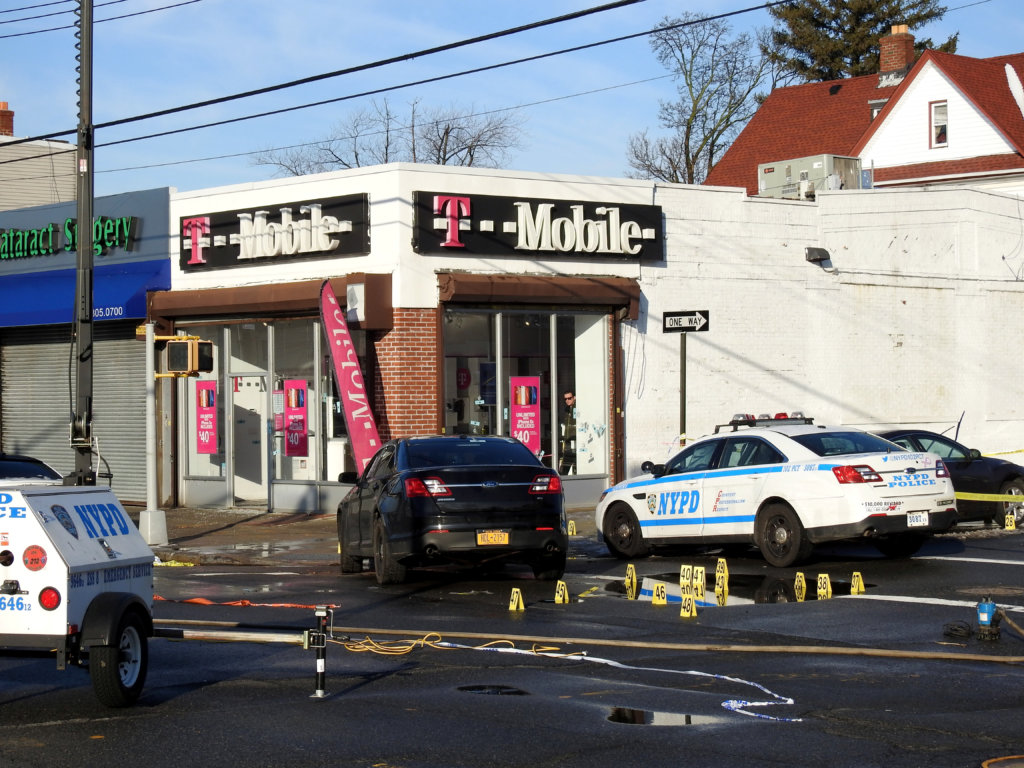 Police continued to collect evidence outside the T-Mobile store on Feb. 13, a day after the deadly robbery.