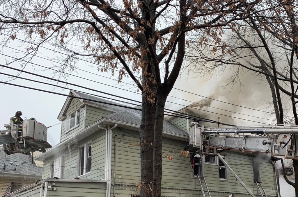 Heavy smoke pours out of the top of an Elmhurst home during a three-alarm fire on Feb. 24.