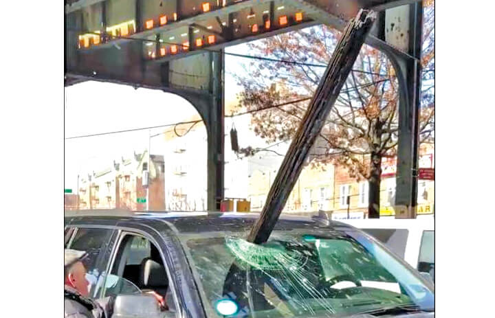 A wooden beam fell off the 7 line in Woodside and crashed through the windshield of an SUV on Feb. 21.