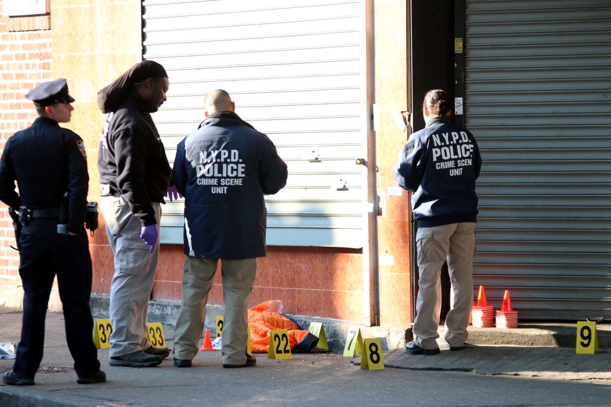 The NYPD Crime Scene Unit marks bullet holes near the RRR Lounge following the March 9 shooting.