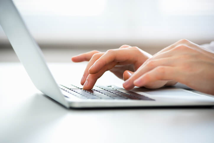 Close-up of hands of business man typing on a laptop.