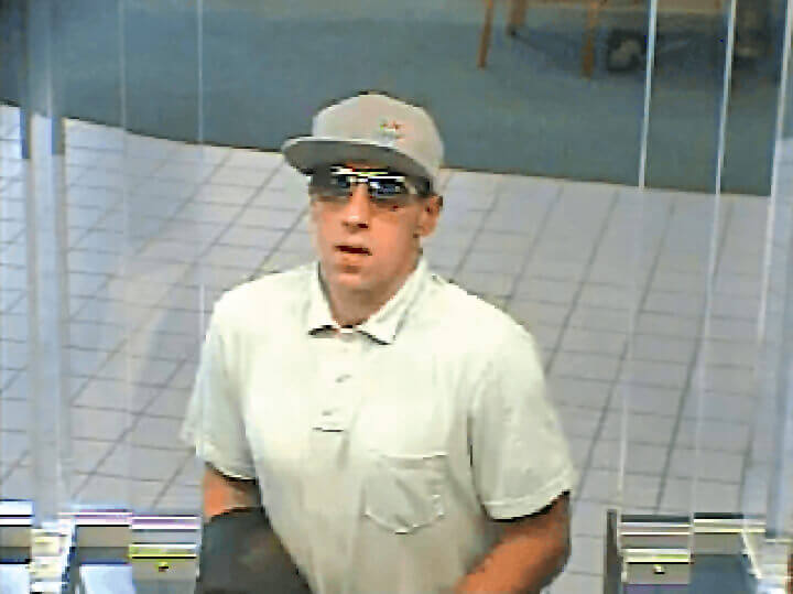 Justin Gass, shown in this security camera photo, admitted to robbing three banks in Queens last summer.