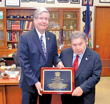 John M. Ryan (at left), shown receiving an award in 2016 from Queens District Attorney Richard A. Brown, is the new acting chief prosecutor for Queens.