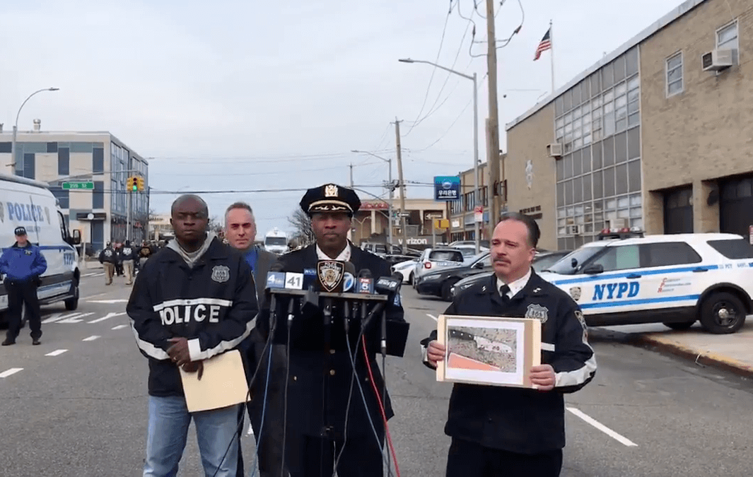 Chief of Patrol Rodney Harrison addresses the press on March 24 as Assistant Chief Martin Morales holds up a knife allegedly held by a man who charged at officers and was subsequently shot outside the 111th Precinct in Bayside.
