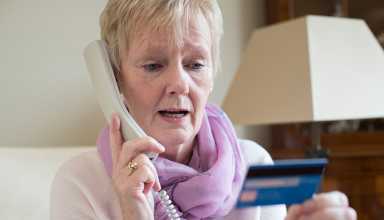 Senior Woman Giving Credit Card Details On The Phone