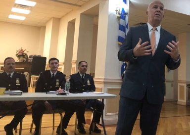 Police Commissioner James O'Neill (at right) addresses residents at the We Love Whitestone Civic Association meeting on April 17.