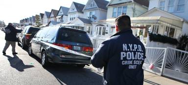 Members of the NYPD Crime Scene Unit seal off an area on 132st Street in South Ozone Park following a deadly shooting on Dec. 11, 2011.