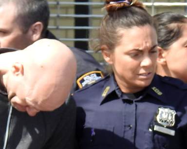 Police Officer Valerie Cincinelli, shown at right while arresting an alleged Howard Beach bank robber in 2017, is accused of attempting to hire a hitman to murder her estranged husband, according to federal agents.