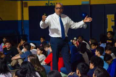 Ivo Philbert of the Jackie Robinson Foundation puts the baseball legend's life in a larger context for the students of Our World Neighborhood Charter Middle School.