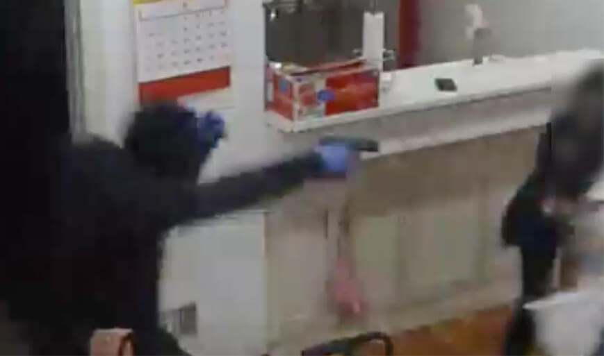 The gun-toting suspect chasing a 34-year-old woman back inside a home during a Little Neck home invasion on May 4.