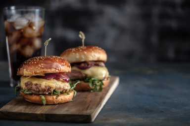 Homemade tasty hamburger with beef, cheese and caramelized onions. Street food, fast food. Copyspace
