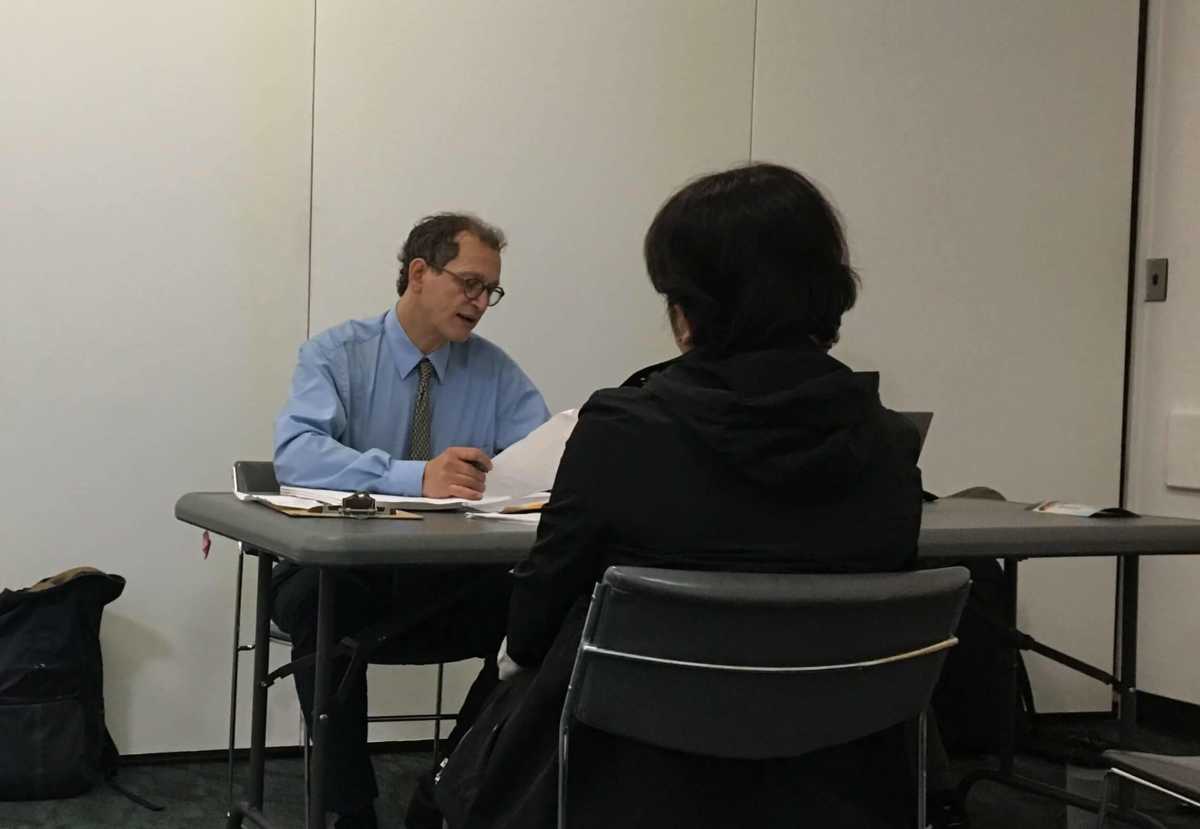 Hearing Officer Bradley Lamel listens to a respondent argue a summons in a pop-up court in Flushing on June 20, 2019.