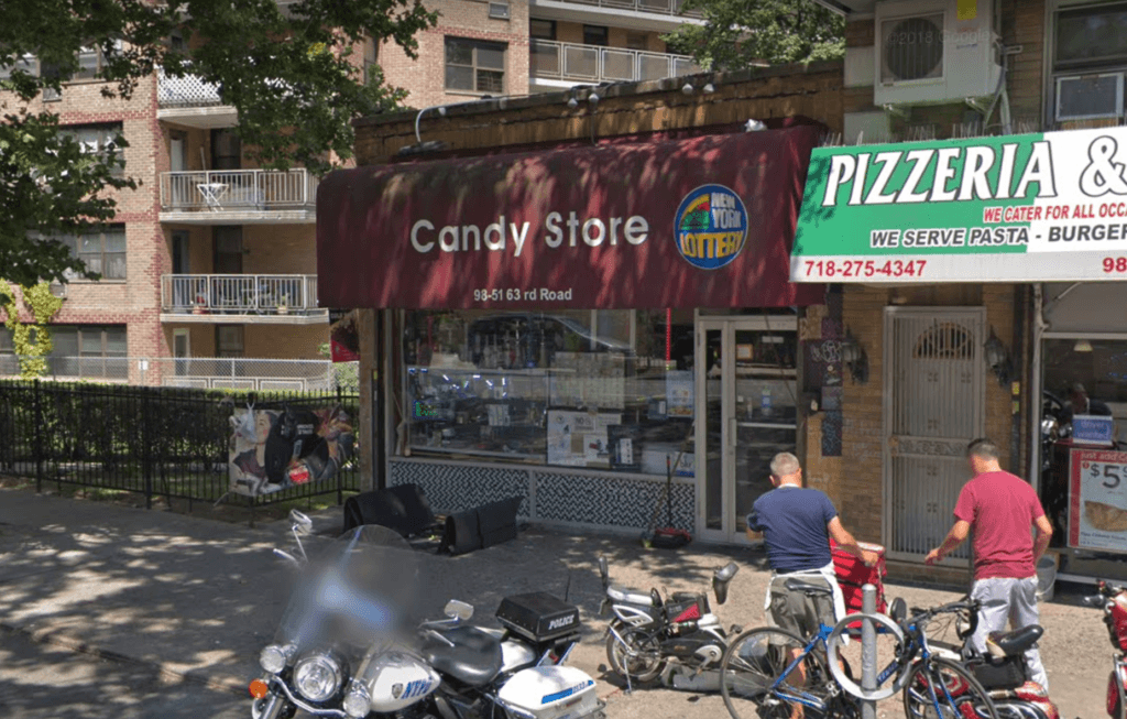 Two armed robbers slashed a worker at this Rego Park candy store in the neck during a robbery on June 15, according to police.