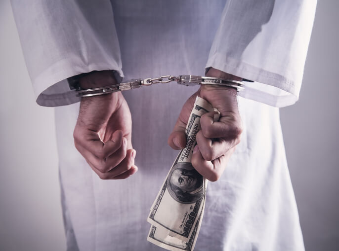 Doctor with handcuffs and money. Medical crime