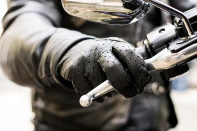 Biker’s hand on brake lever handlebar