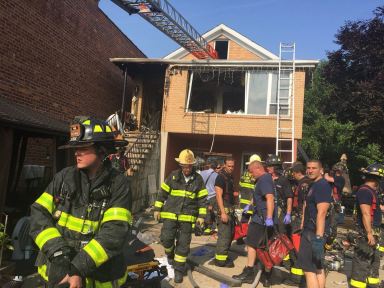 Firefighters at the scene of a deadly fire in East Elmhurst on July 10.
