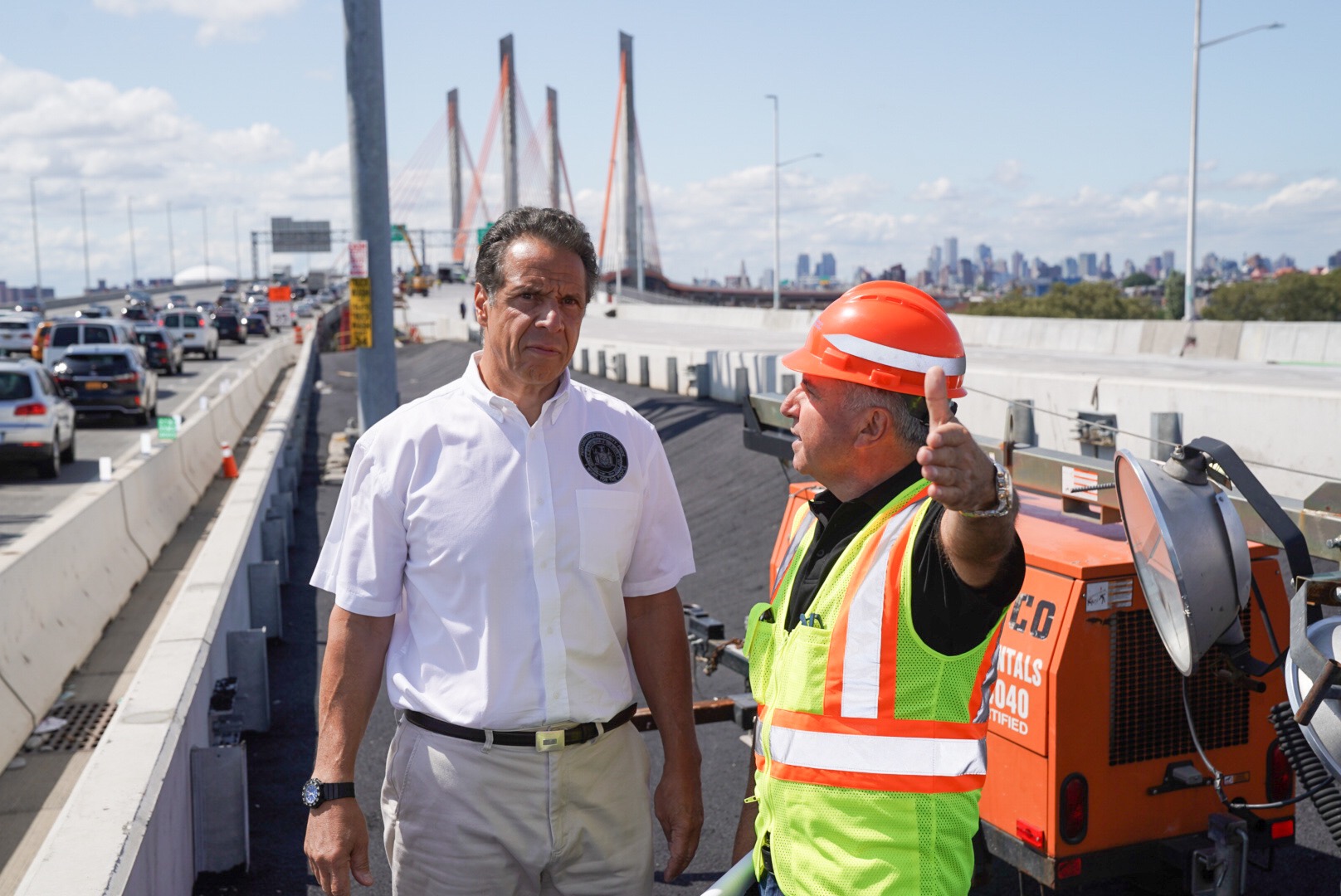 Governor Andrew Cuomo and a construction worker survey the second span of the new Kosciuszko Bridge, which is set to open Aug. 29.