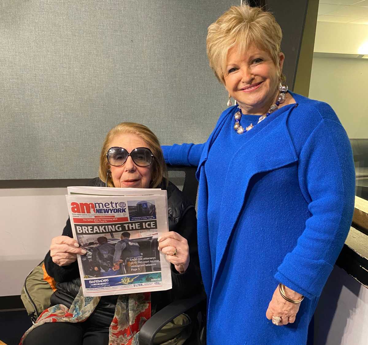 With Joan Hamburg holding up a recent edition of amNewYork Metro