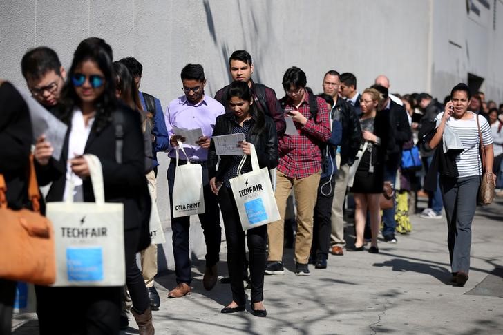 FILE PHOTO: People wait in line to attend TechFair LA, a technology job fair, in Los Angeles