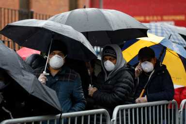 People queue at the Elmhurst Hospital Center to be tested for the coronavirus disease (COVID-19) in Queens, New York City