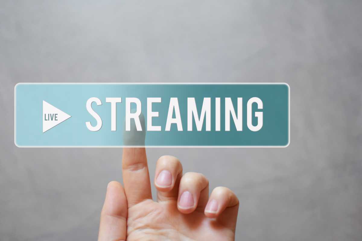 Live streaming – hand pressing transparent blue button