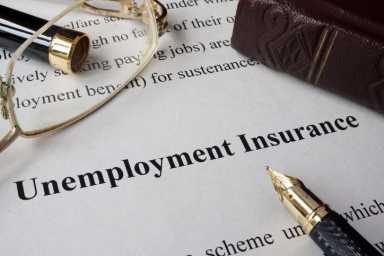Unemployment insurance concept written on a paper.