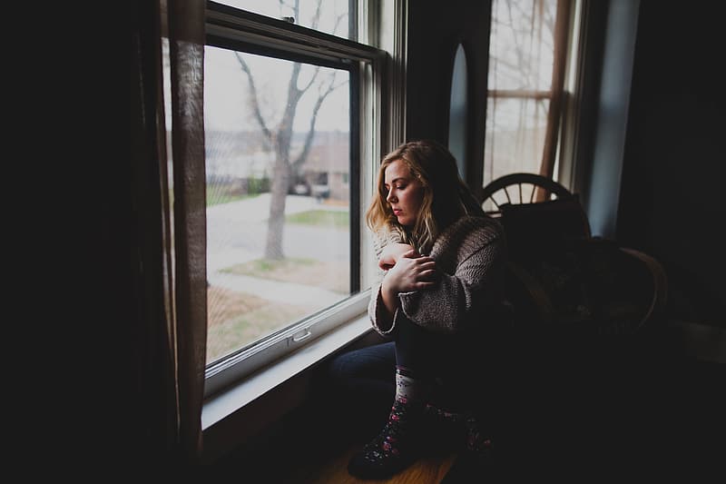 woman-near-window-watching-outside-photography