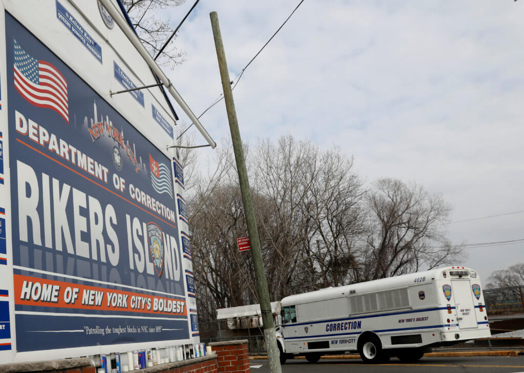 FILE PHOTO: An NYC Department of Corrections vehicle drives in the entrance to Rikers Island facility in Queens, in New York