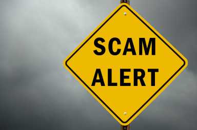 Scam alert conceptual traffic sign and stormy sky