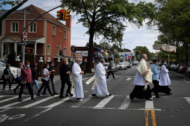 Priest leads Blessed Sacrement procession through Queens neighborhood during outbreak of the coronavirus disease (COVID-19) in New York