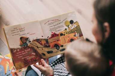 woman-reading-book-to-toddler-1741231-1200×800