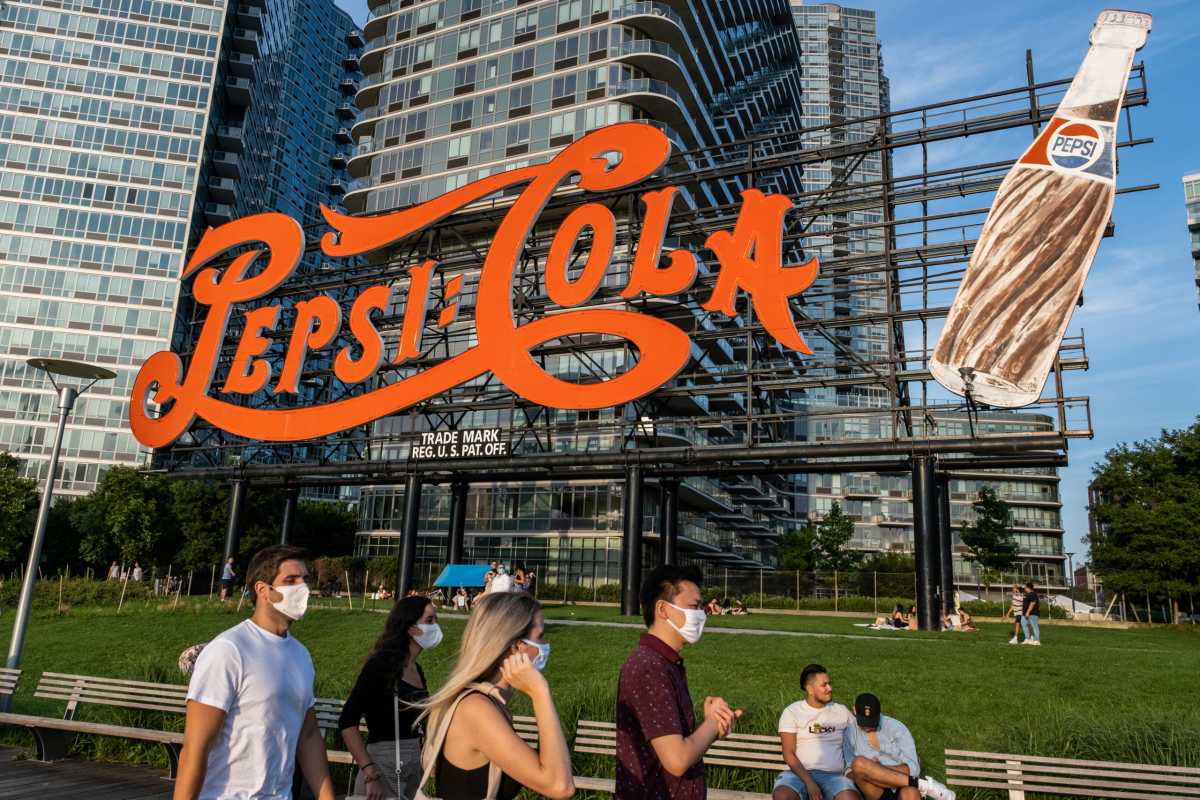 People try to maintain social distance while enjoying a warm and humid day at Gantry Plaza State Park following the outbreak of the coronavirus disease (COVID-19), in Long Island City, New York