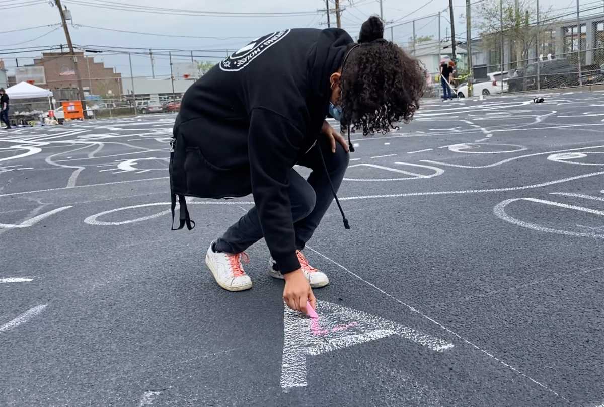 Shantell Martin sketching mural outline