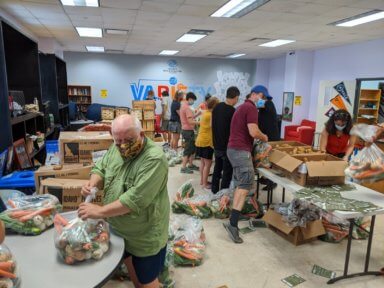 Volunteers package items at Queens Together – Boys & Girls Club Pantry