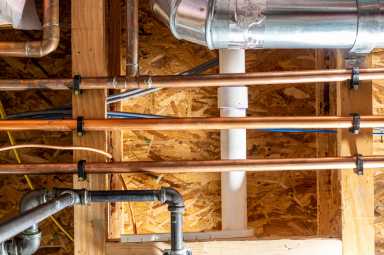 Ceiling with multiple utility lines – gas, electrical, water, internet, and sewer