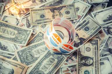 I vote Today stickers on a pile of American dollar bills, political election concept of economy and democratic elections in the USA.