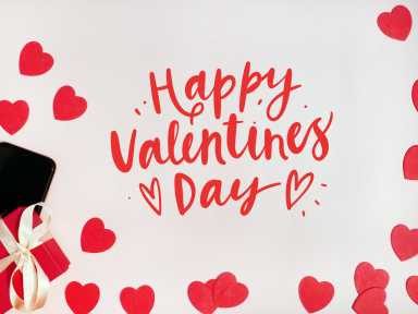 Valentine’s day card. Composition with gifts, red hearts, mpbile phone and sign Happy Valentines Day on white surface