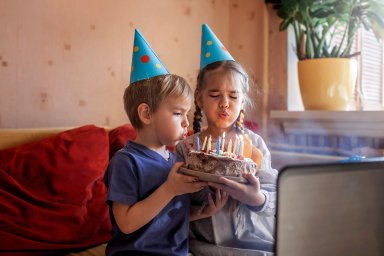 Happy father with two sibling celebrating birthday via internet in quarantine time, self-isolation