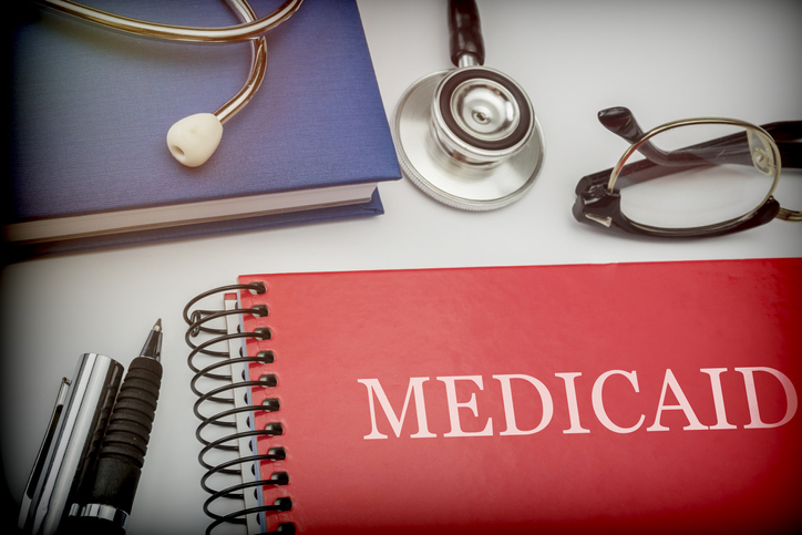 Titled red book medicaid along with medical equipment, conceptual image