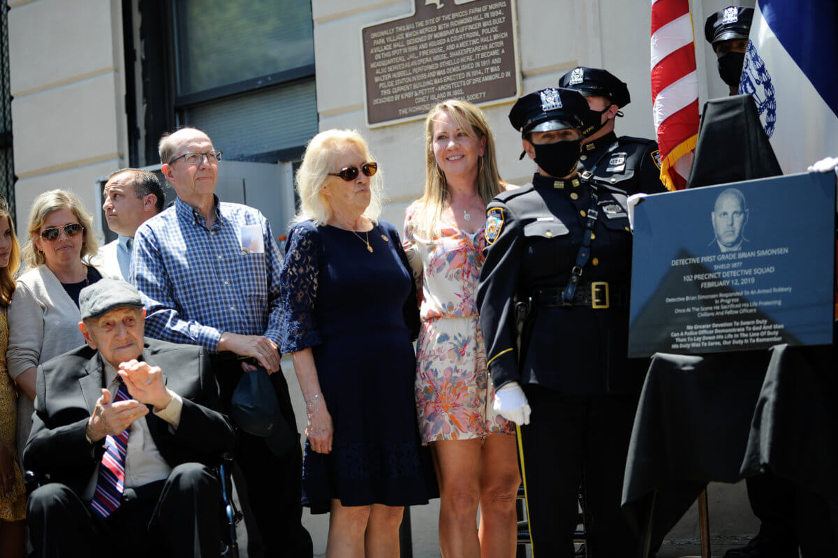 The Simonsen family with the dedicated plaque to Detective Brian Simonsen.