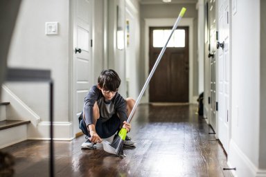 Young boy doing cleaning and doing chores