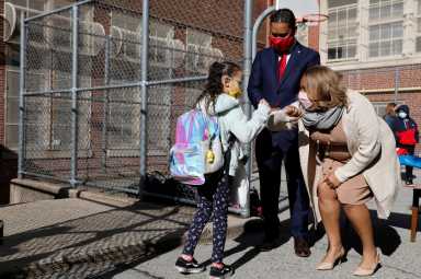 Meisha Porter, Chancellor of the New York City Department of Education, greets students as they return to school in Manhattan, New York