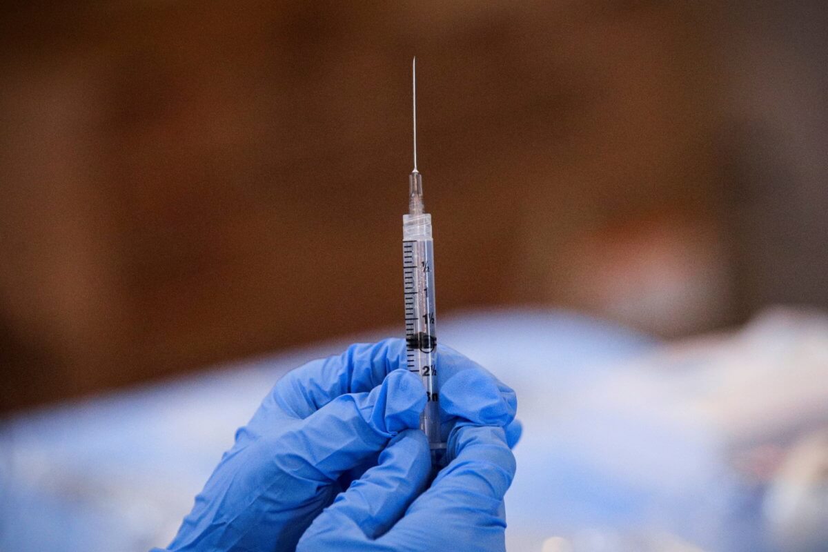 FILE PHOTO: A syringe is filled with a dose of Pfizer’s coronavirus disease (COVID-19) vaccine  at a pop-up community vaccination center in Valley Stream, New York