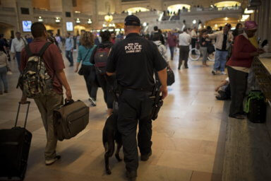 A MTA Police K9 team patrols through New York’s Grand Central Terminal